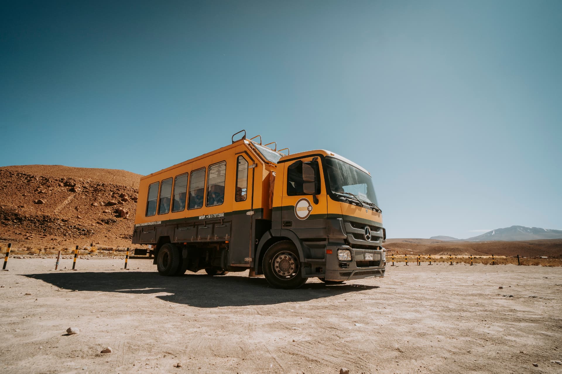 Bus safári da Grado 10 estacionado em meio às paisagens do Deserto do Atacama