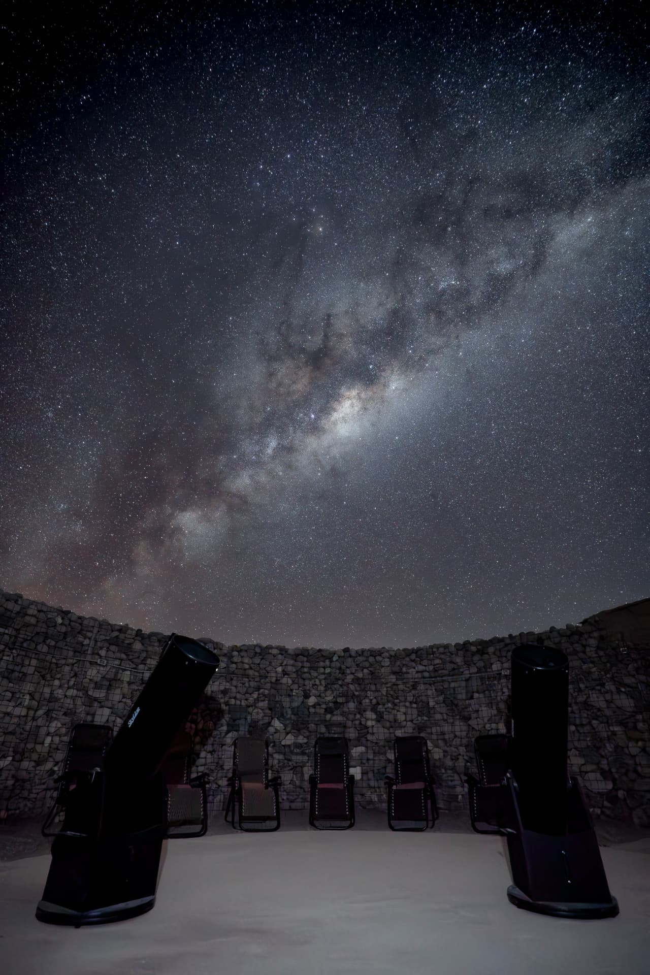 Espreguiçadeiras e telescópios sob a Via Láctea na estrutura do Tour Astronômico - Orbit 10